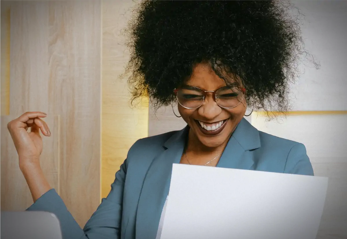 Woman smiling while looking at documentation